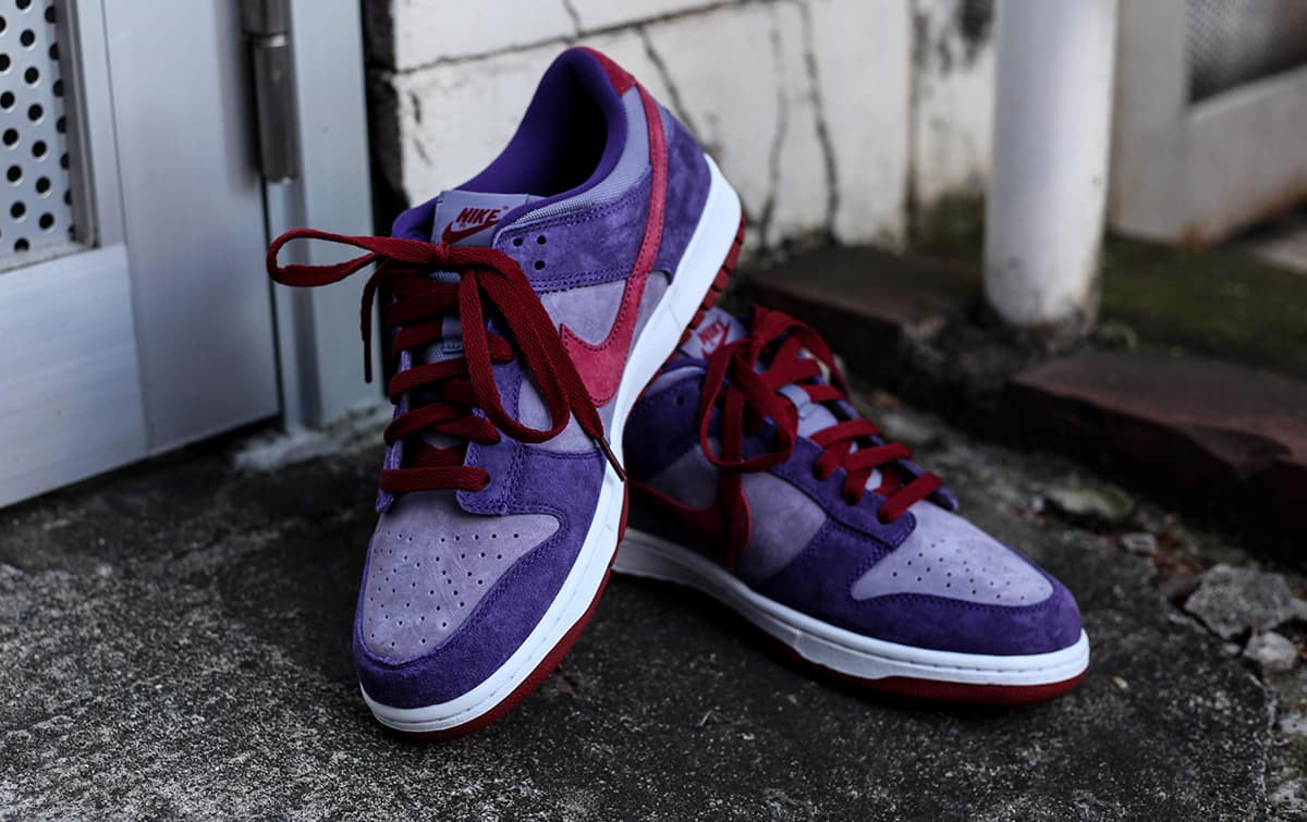 white and purple hi top nike dunks with black shoestrings