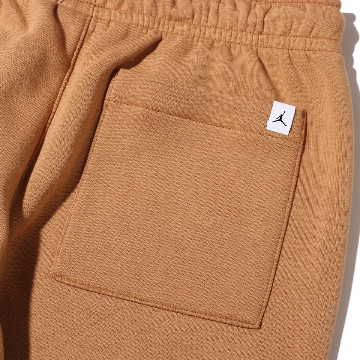 JORDAN BRAND AS M J ESS MMBR FLC PANT LEGEND DK BROWNの画像